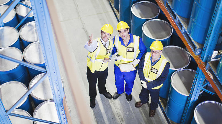 3 men with yellow hard hats inspecting