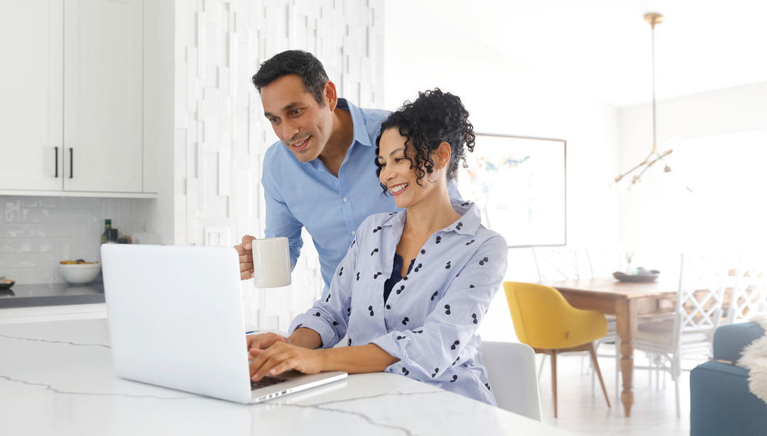 Couple looking at a laptop screen together