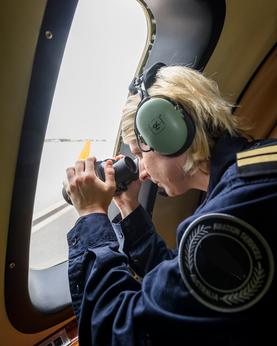 Woman doing a visual search from a plane.