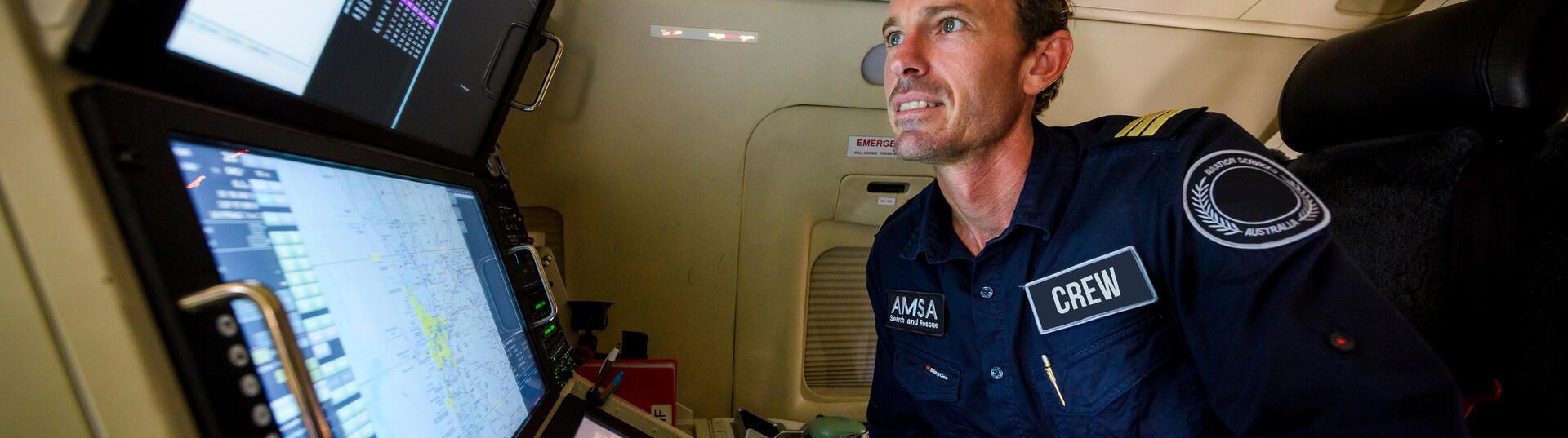 Man looking at screens