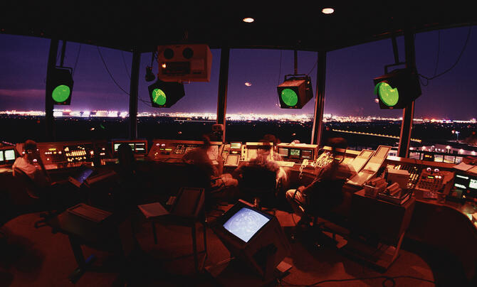 Air traffic controllers in tower at night