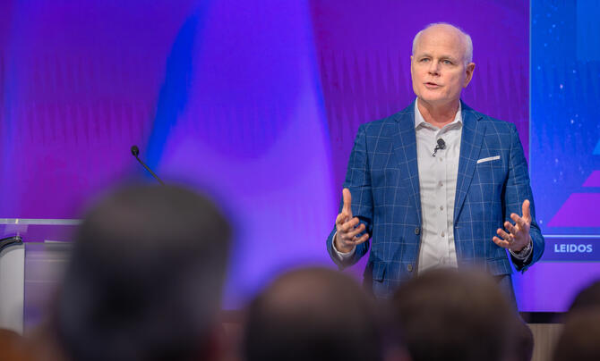 Leidos CEO Tom Bell addressing audience