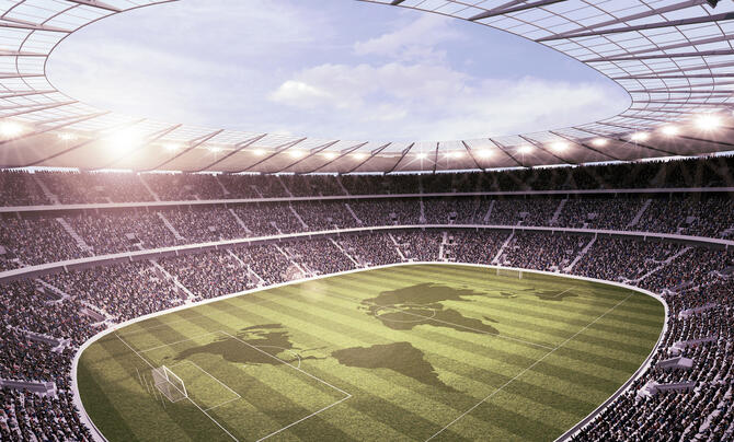 Overhead photo of a soccer stadium with the shapes of countries on the pitch