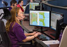 photo of a command center with employees on their computers supporting the FAA