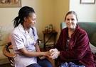 nurse in care home with older woman