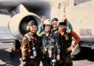 Lisa with colleagues in front of Navy plane