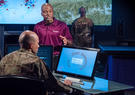 Leidos employee assists military personnel with technology.