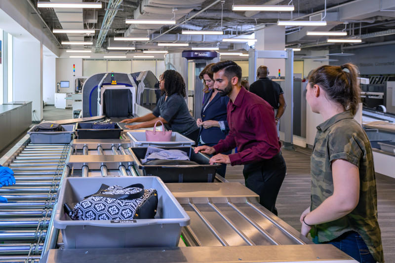 Bags going through Leidos scanners