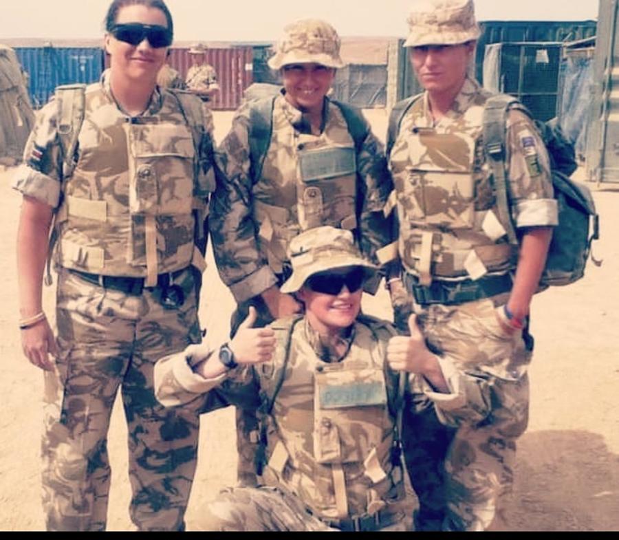 group of soldiers in camo posing for photo