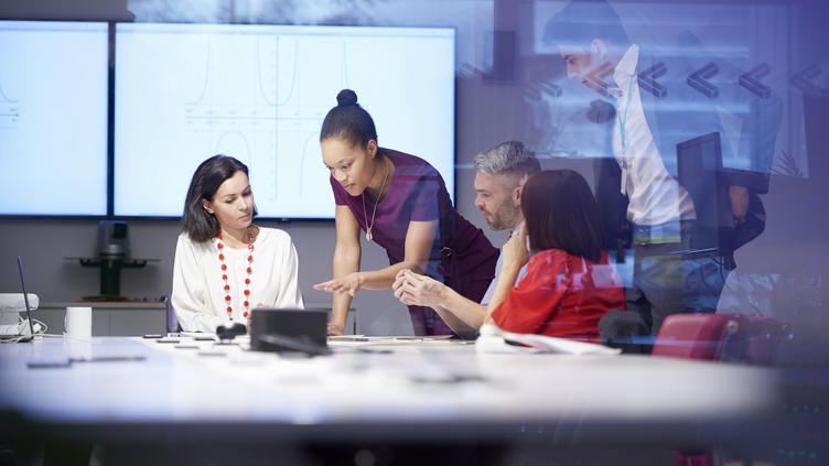 group of people around a table in discussion