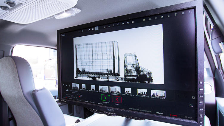 View from the backseat of a vehicle scanning truck beside it