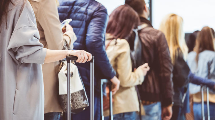 people standing in line at the airport