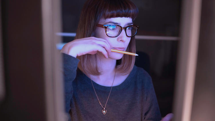 Woman sitting working at a computer