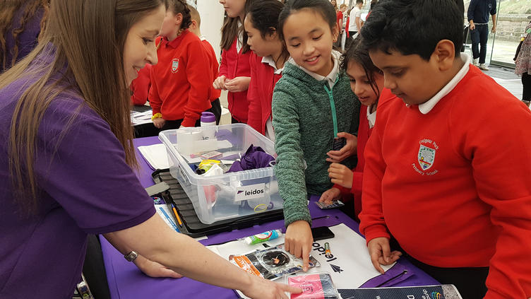 Leidos volunteer working with school children