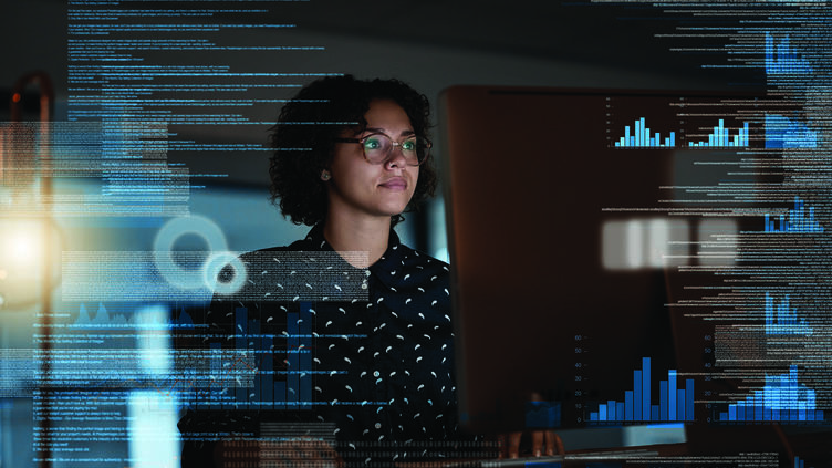 Woman at computer with graphical charts