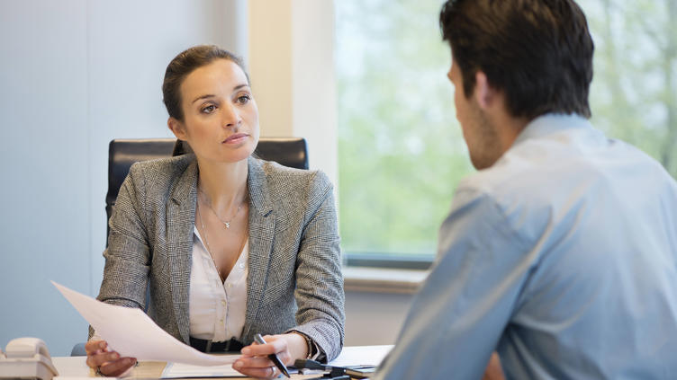 woman holding document discussing with man