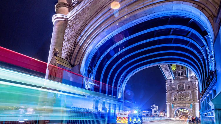 UK police van with lights on Tower Bridge