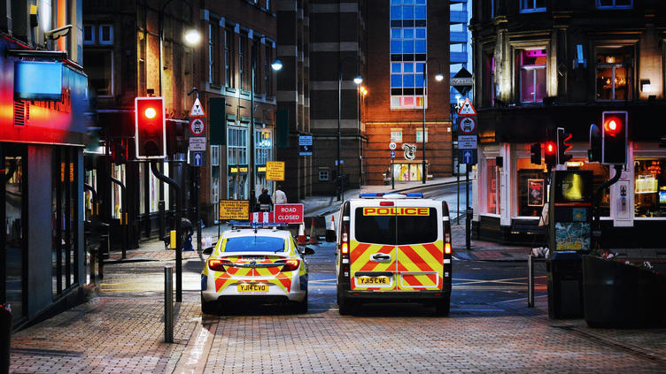 UK police vehicles at city traffic lights