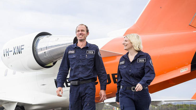 Man and woman walking away from airplane