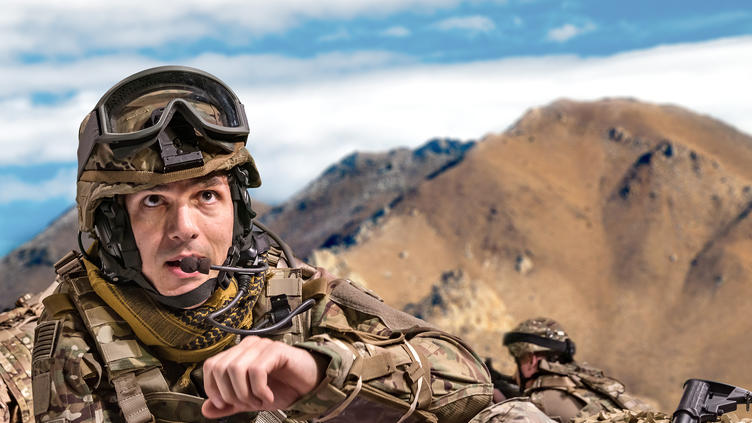 solider on ground with communications gear on