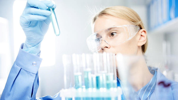 Scientist looking at test tube