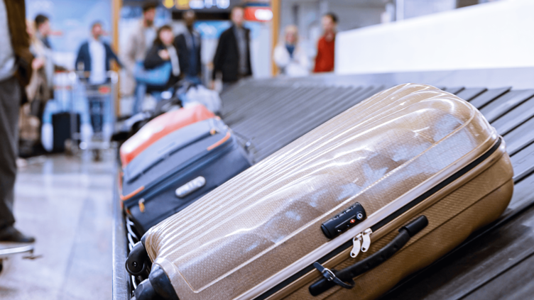 Checked baggage on a carousel at an airport