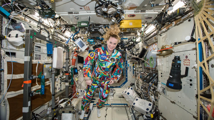 Kate Rubins with colorful space suit on